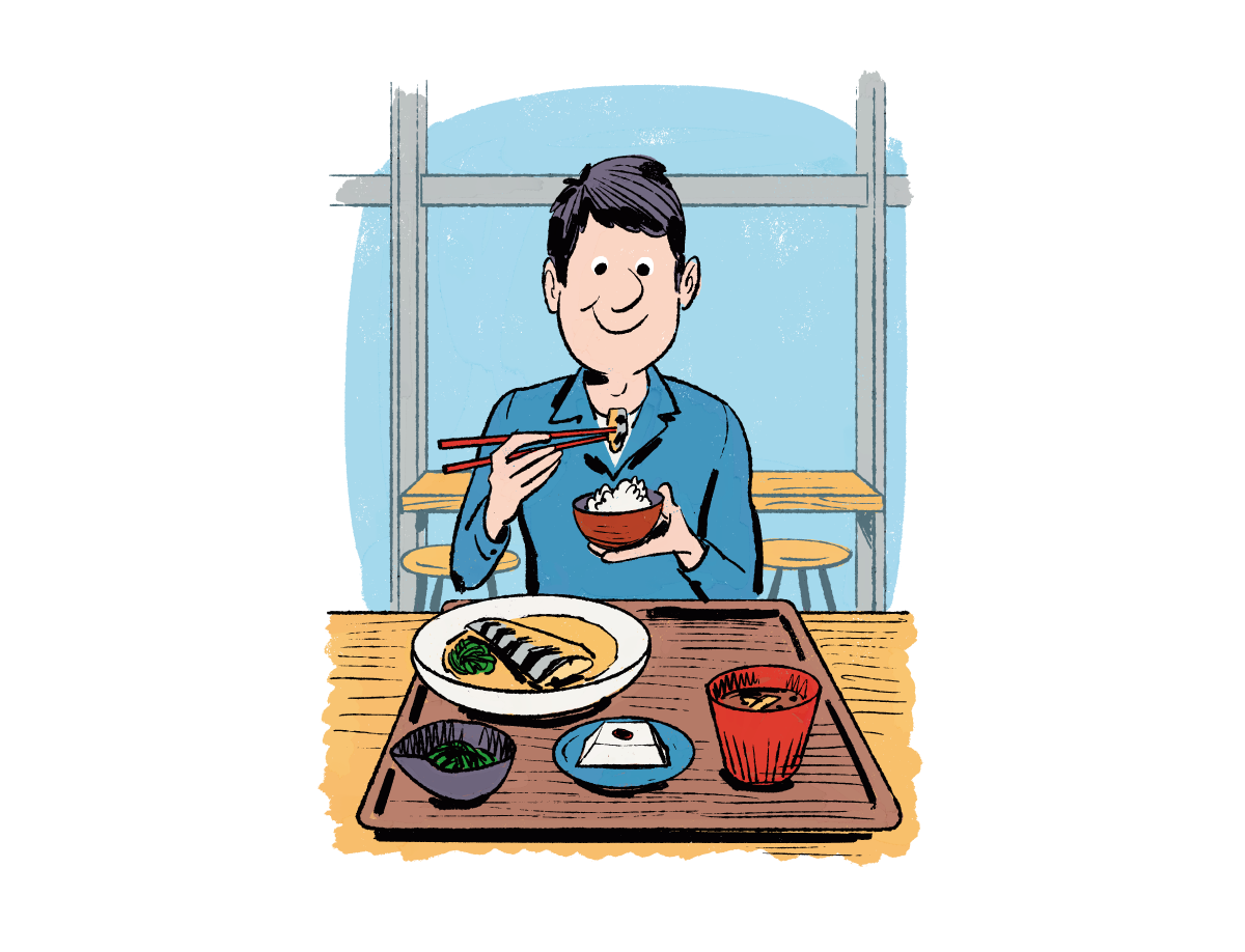 男性が魚定食を食べている様子